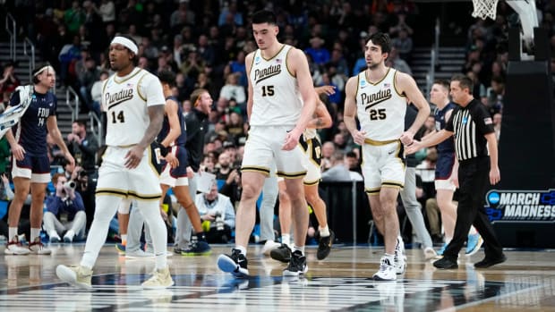 Purdue men’s basketball players David Jenkins Jr., Zach Edey and guard Ethan Morton walk to bench.